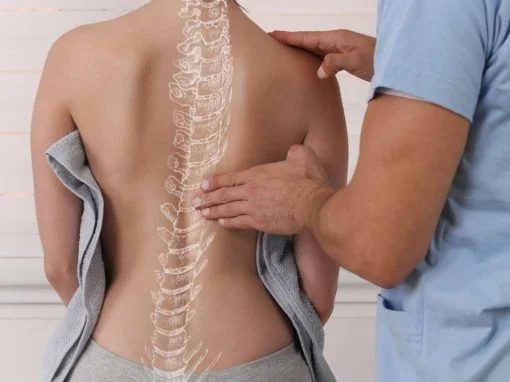 Physio, chiro or osteo Health professional looking at a patient's back with graphic of spine superimposed » HCi