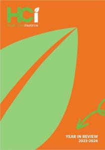 Front cover of the HCi year in review 2023-24 document. It is orange with a green leaf under the HCi logo » HCi