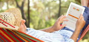 hci_oms_man-hammock-tablet-441x208 » HCi Man relaxing in a hammock while looking at OMS, the secure HCi member portal - a great tool for claiming health cover